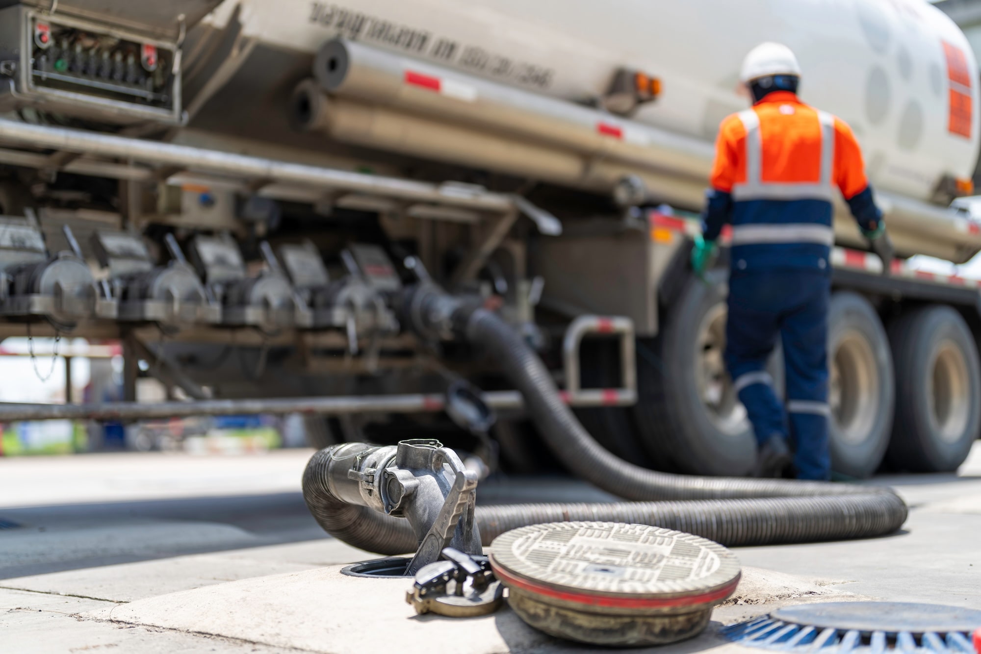 Service man distributing fuel and gas to independent gas station